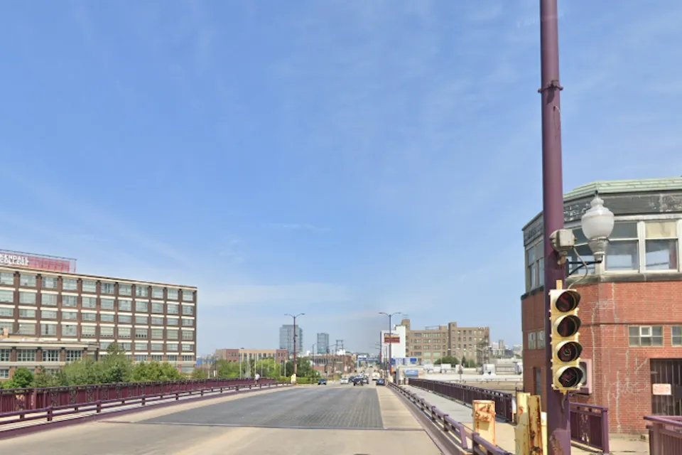 Google street view of wide bridge over Chicago River with small brick towers at corners.